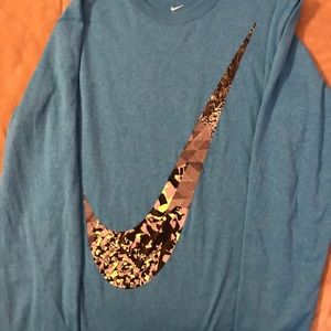 Youth X-large Nike long sleeve dri-fit blue shirt.  Large Nike Swoosh on front.